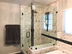 Frameless glass shower enclosure in a remodeled bathroom