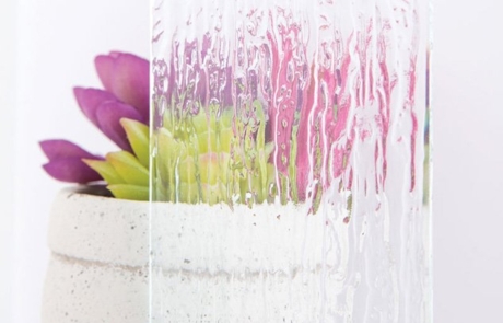 Rain Glass Sample Sample image of rain textured glass in front of succulent plant and vase.